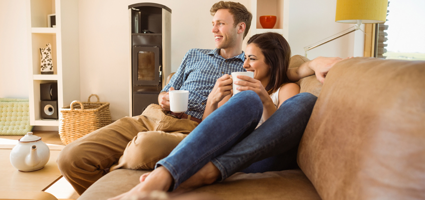 Couple Sitting at Home Drinking Coffee