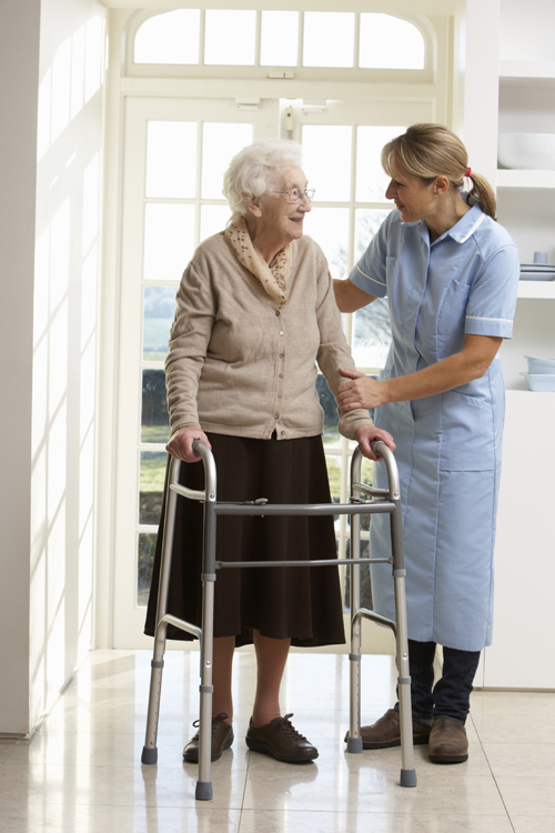 Woman Helping Elderly Person in Facility