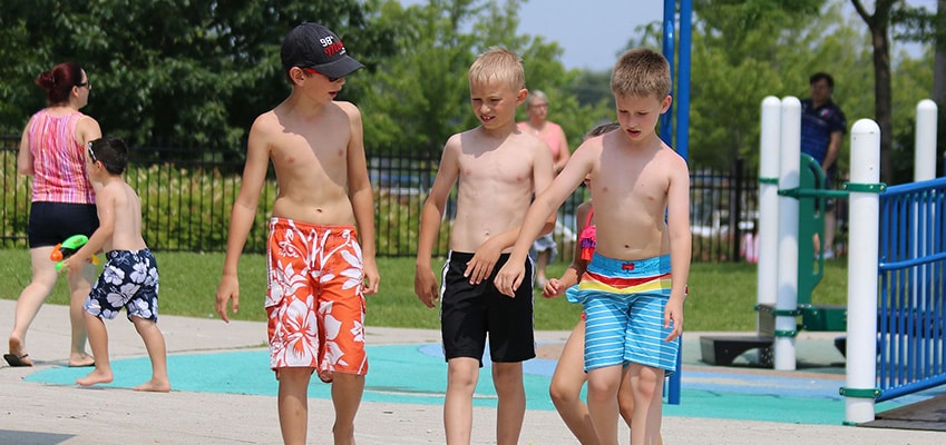 4 boys chatting within a waterpark